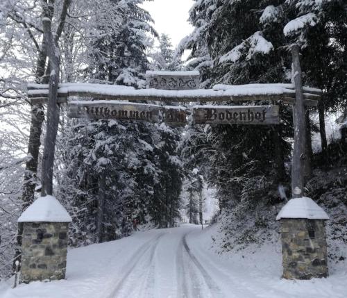 a sign on a road with snow on it at Bodenhof Ferienwohnungen in Fieberbrunn