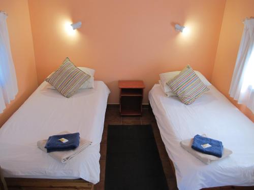 two beds in a room with towels on them at Coral Divers in Sodwana Bay