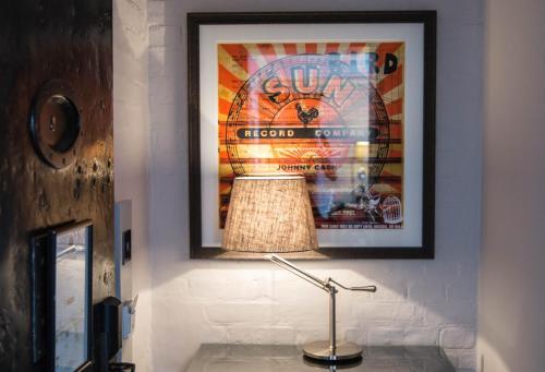 a lamp in a room with a picture on the wall at Malmaison Oxford in Oxford