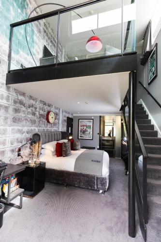 a bedroom with a large bed with a glass ceiling at Malmaison Oxford in Oxford