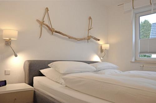 a bedroom with a bed with two white pillows at Villa Herbstwind in Binz in Binz