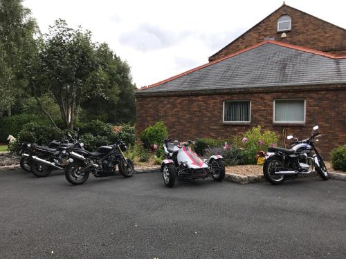 three motorcycles parked in front of a house at The Stables B&B in Antrim