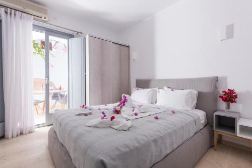 a bedroom with a large bed with flowers on it at Blue Waves Suites & Apartments in Kamari