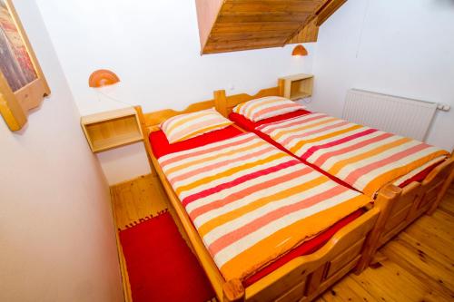 a bed with two pillows on it in a room at Tourist Farm Pri Martinovih in Krška Vas