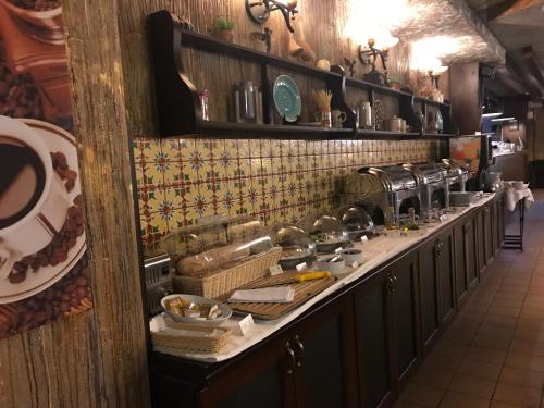 a kitchen with a long counter with alot of dishes at Park-Hotel Golosievo in Kyiv