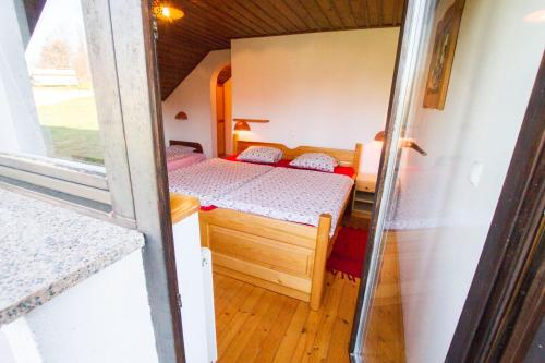 a small bedroom with a bed in a tiny house at Tourist Farm Pri Martinovih in Krška Vas