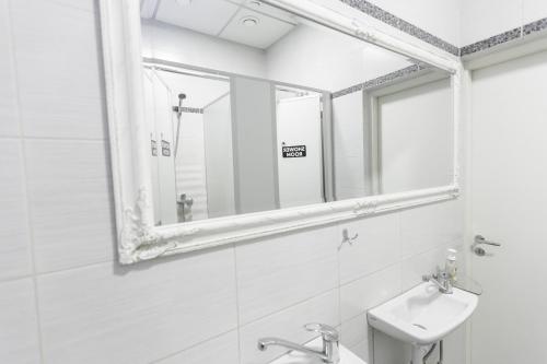 a bathroom with a mirror and a sink at Sports Hostel in Kaunas
