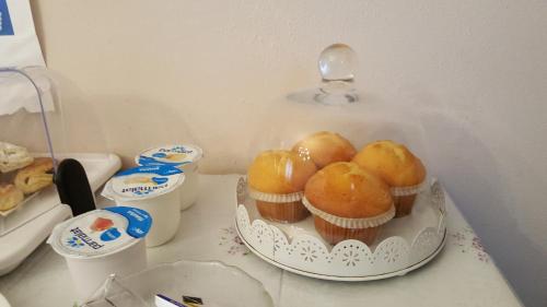 a table with a plate of cupcakes on it at Il Linchetto in Lucca