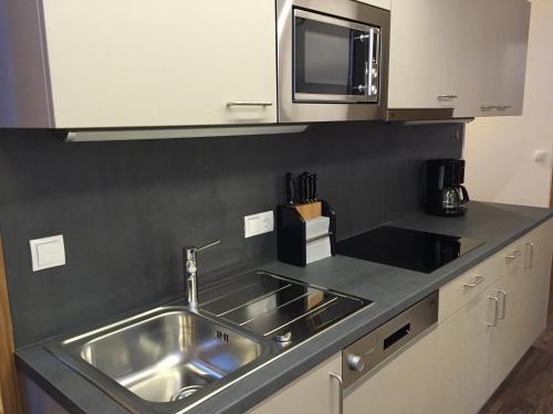 a kitchen with a sink and a microwave at Nonas B&B in Galtür