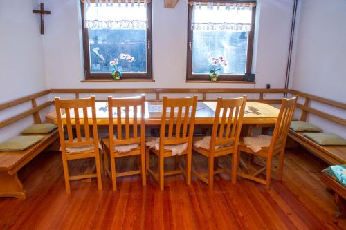 a dining room with a wooden table and chairs at Tourist Farm Pri Martinovih in Krška Vas