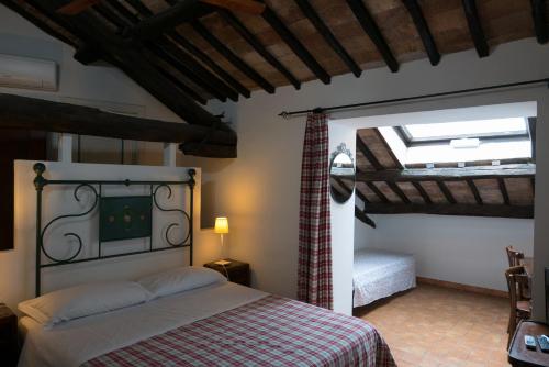 a bedroom with a bed in a room with a window at La Soffitta e La Torre in Orvieto