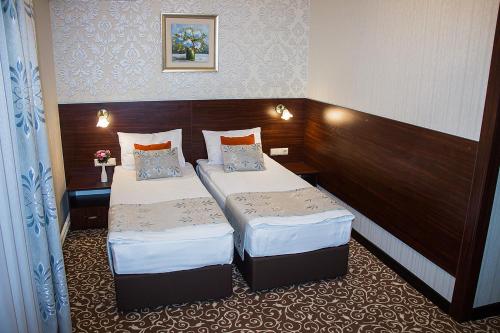 a hotel room with two beds in a room at Silk Way in Almaty