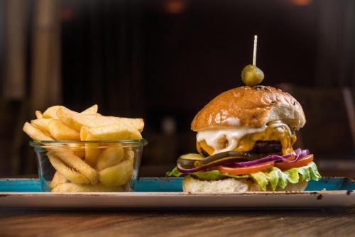 a sandwich and chips with a pickle on top of it at Ko´Ono Hotel in Konstanz
