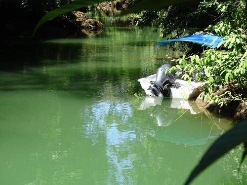 a boat sitting in a body of water at Hostel Osa Tucan Drake in Drake