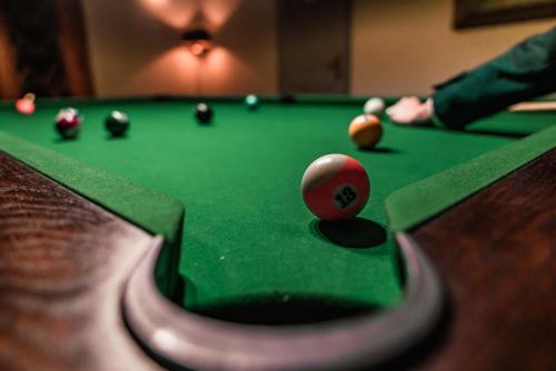 a cue ball on top of a pool table at Pałac na Wodzie Hotel & SPA in Jelenia Góra