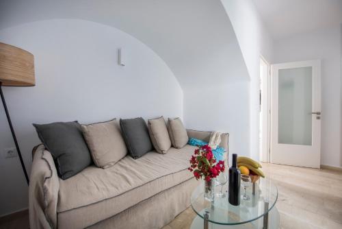 a living room with a couch and a glass table at Blue Waves Suites & Apartments in Kamari