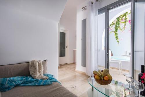 a living room with a couch and a glass table at Blue Waves Suites & Apartments in Kamari