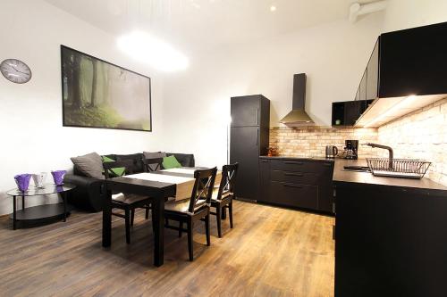 a kitchen and a dining room with a table and chairs at Lana Appartements in Vienna