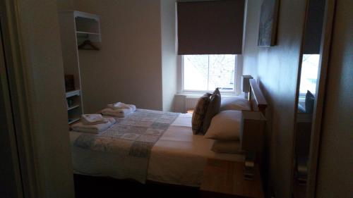 a bedroom with a bed with towels on it at The Badger Inn in Carbis Bay
