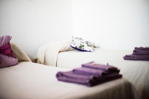 two purple towels are sitting on a bed at Amor di Lavanda in Cingoli