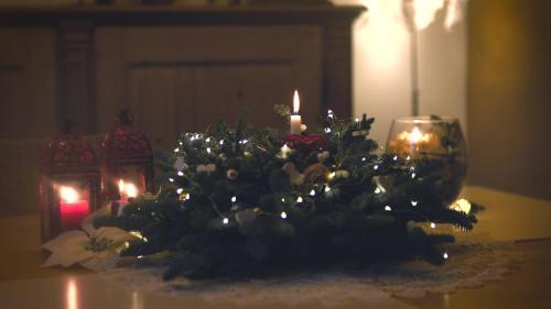 a christmas centerpiece with candles and flowers on a table at B&B Terre Di Bea in Pederobba