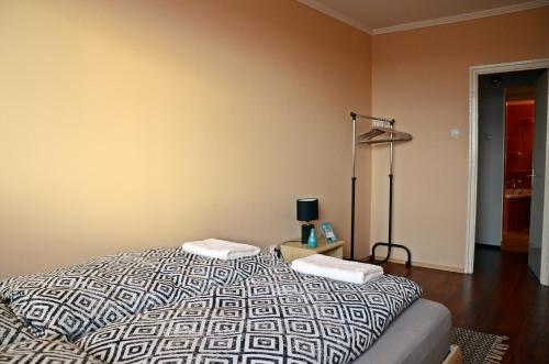 a bedroom with a bed and a lamp at Panorama View Family Apartment in Veszprém