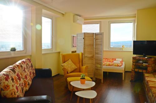 ein Wohnzimmer mit einem Sofa und einem Tisch in der Unterkunft Panorama View Family Apartment in Veszprém