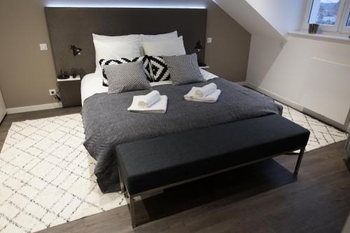 a bedroom with a large bed with two slippers on it at Luxueux logement Bourgeois de 250 M2 climatisé in Lille