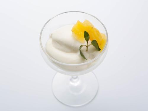 a glass cup filled with yogurt and a piece of pineapple at 源泉掛け流しの宿Albergo湯楽 in Yugawara