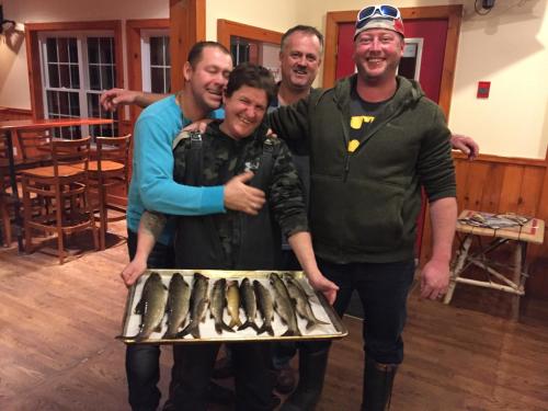 a group of people posing with a tray of fish at Little Hawk Resort & Marina in Algonquin Highlands
