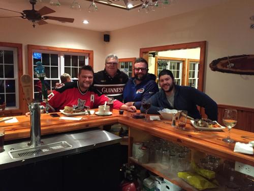 a group of men sitting at a bar at Little Hawk Resort & Marina in Algonquin Highlands
