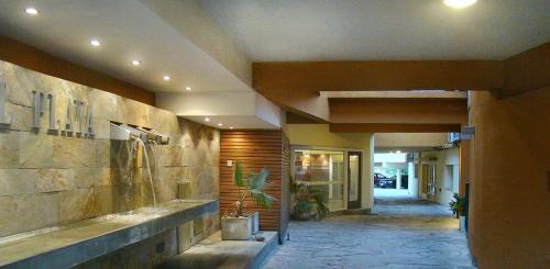 a hallway of a building with a potted plant at Hotel Playa in Villa Carlos Paz