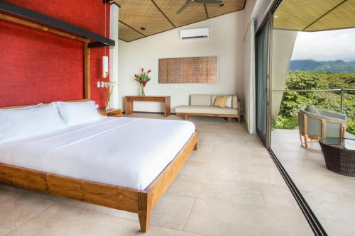 a bedroom with a bed and a balcony at Hotel Three Sixty - Adults Only in Ojochal