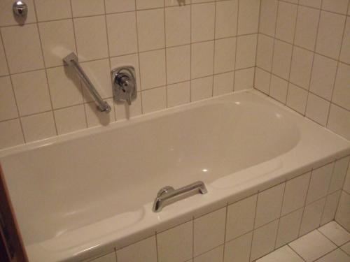 a bath tub with a faucet in a bathroom at Haflingerhof Appenstein in Pinswang