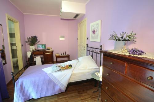 a bedroom with a bed with a plate of food on it at Villa Vecchio in Castagnito
