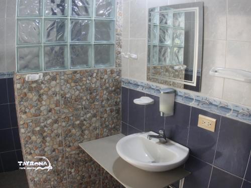 a bathroom with a sink and a mirror at Tayrona Dive Center in Taganga