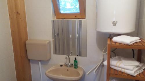 a small bathroom with a sink and a toilet at Remser Haus in Zalakaros