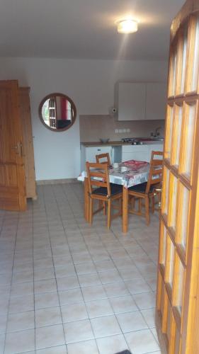 a kitchen and dining room with a table and chairs at Remser Haus in Zalakaros