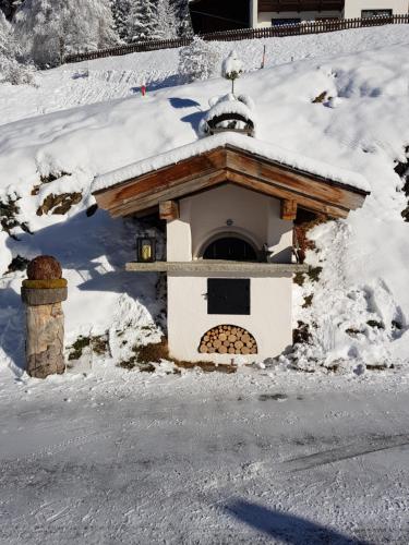 a small house with a snow covered roof at Haus Auer in Jerzens