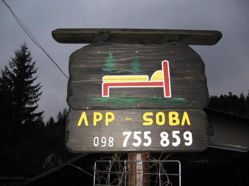 a sign with a chair on top at Apartments Gale in Delnice