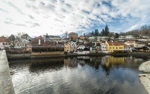 a view of a town with a river and buildings at Babylon Apartmány in Český Krumlov