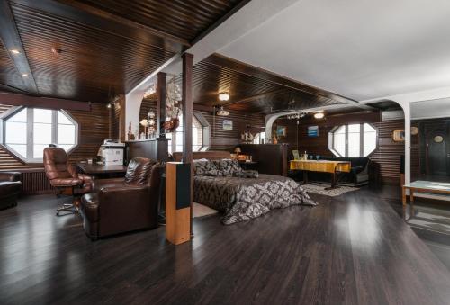a bedroom with a bed and a desk in a room at The Sky Loft in Kyiv