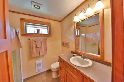 y baño con lavabo, aseo y espejo. en Nakiska Ranch, en Clearwater