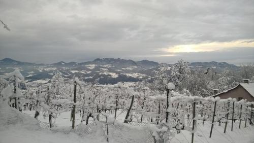 a fence covered in snow with mountains in the background at Getaway "At the three lights" in Sevnica