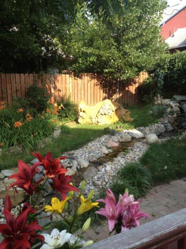 a garden with flowers and a fence at Burnt Toast Inn in Ann Arbor