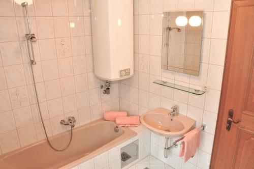 a bathroom with a sink and a bath tub and a sink at Ferienwohnung Vera in Scharnitz