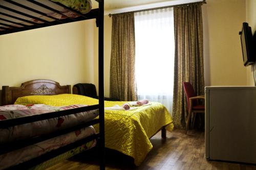 a bedroom with two bunk beds and a window at Malva in Lviv