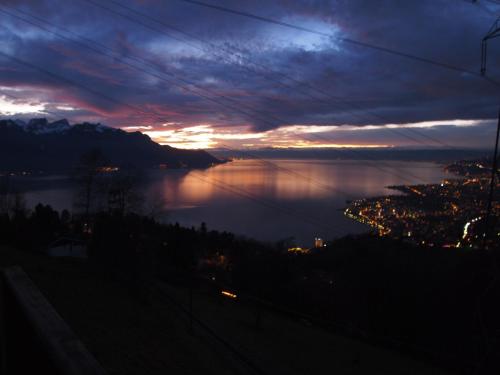 a view of a body of water at sunset at Gais Alpins in Montreux