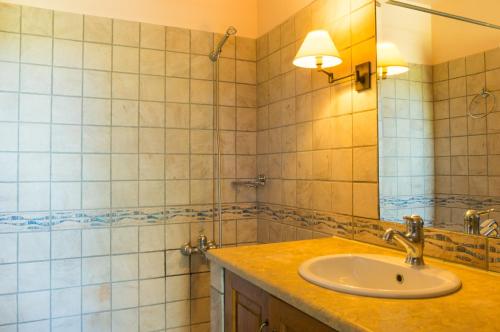 a bathroom with a sink and a mirror at Writers' Retreat in Xilokastro in Xylokastro