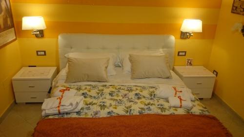a bedroom with a large bed with two night stands at Affittacamere Villa Giulia in Moneglia